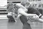  ?? FRANK DIRENNA/COLUMBUS DISPATCH ?? Olentangy’s Luke Mokros lifts Gahanna Lincoln’s Carson Carroll during their match at 106 pounds in the Division I district tournament at Hilliard Darby.