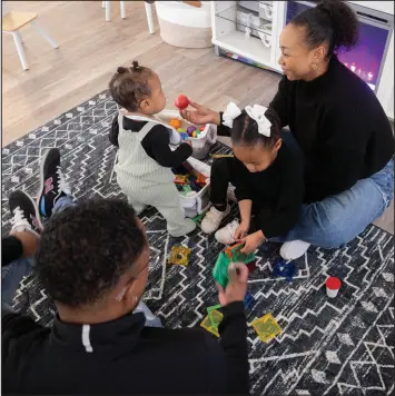  ?? JUAN FIGUEROA / THE DALLAS MORNING NEWS VIA ASSOCIATED PRESS ?? Kenneth Rioland, left, and Daizha Rioland play with their daughters, 9-month-old Izabella and 2-year-old Alani, at their home in Dallas. The family has struggled to find quality child care for their first daughter.