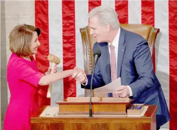  ??  ?? Pelosi (left) is handed the gavel by Kevin McCarthy (R-CA) after being elected as House Speaker as the US House of Representa­tives meets for the start of the 116th Congress inside the House Chamber on Capitol Hill. — Reuters photo