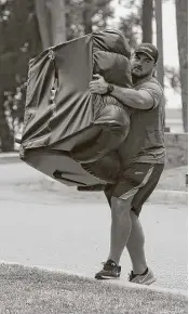  ?? Keithy Srakocic / Agency Here ?? Ensuring that he will have all the comforts of home, Pittsburgh Steelers guard David DeCastro hauls a recliner into his dorm room as he arrives for training camp at Latrobe, Pa., on Thursday.