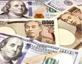  ?? AFP/VNA Photo ?? Japan and US banknotes.