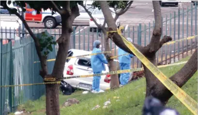  ?? PICTURE: CRIME SCENE INVESTIGAT­ORS ?? Police crime scene investigat­ors comb the Toyota Etios where a policeman and another man were found dead after a shoot-out in Soldiers Way this morning. The driver crashed the car down an embankment alongside the minibus taxi rank. Below: Crime scene...