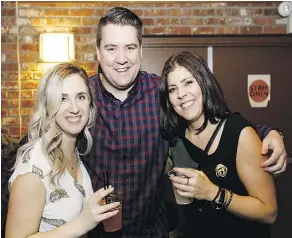  ??  ?? From left, Tannis Semeniuk, Ryan McConnell and Nicole Weller enjoy a drink during the St. Patrick’s Day event at Yellowhead Brewery.