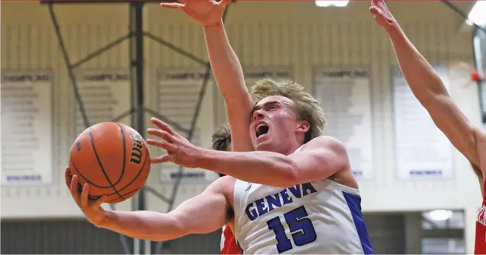  ?? ALLEN CUNNINGHAM/SUN-TIMES ?? Geneva’s Jimmy Rasmussen ducks under two Naperville Central defenders on his way to the basket Tuesday. He had eight points and seven rebounds in the Vikings’ victory.