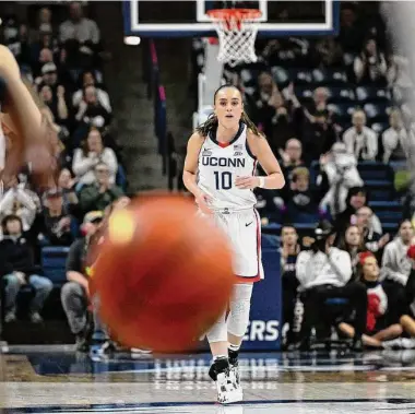  ?? Jessica Hill/Associated Press ?? Nika Muhl backpedals down court after breaking UConn’s single-season assist record previously held by Sue Bird on Feb. 27 against Xavier.