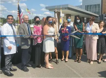  ?? MICHELLE MULLINS/DAILY SOUTHTOWN ?? Will County Health Department Executive Director Susan Olenak cuts the ribbon officially opening the department’s new facility Sept. 10.