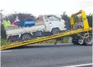  ?? Photo / John Stone ?? The loaded ute is removed from the accident scene.