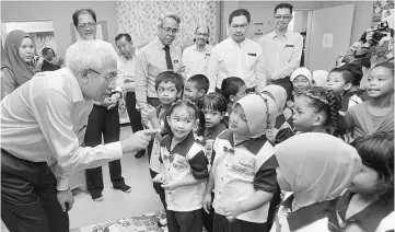  ??  ?? Mahdzir shares a light moment with pupils after launching the Reproducti­ve Health and Social Education (Peers) at Sekolah Kebangsaan Putrajaya Precinct 17 (1). — Bernama photo