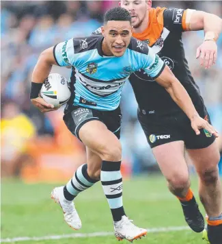  ??  ?? OPTIONS: Cronulla’s Valentine Holmes making a break against the West Tigers.