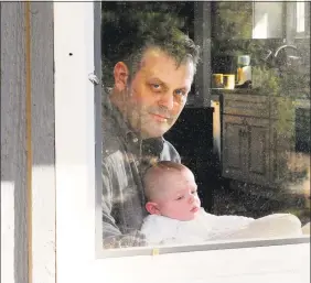  ??  ?? Chris Tillett with his son John at his home in Wilton on Thursday.