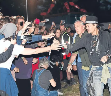  ??  ?? JOHNNY Depp joked about assassi- nating President Donald Trump during an appearance at Glastonbur­y.
The Hollywood actor received a rock star welcome during the event at Cineramage­ddon — a drive-in cinema on the Somerset site.
He introduced his 2004...