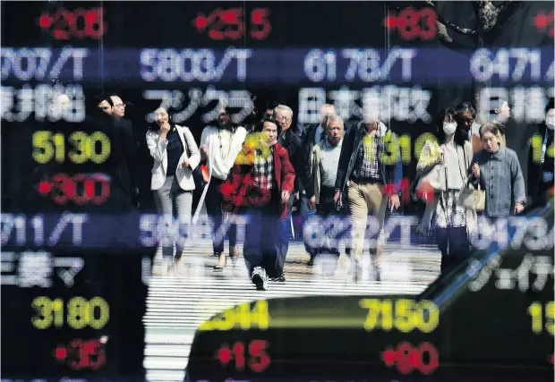  ?? TOSHIFUMI KITAMURA / AFP / GETTY IMAGES ?? Tokyo stocks opened higher on Tuesday, following a rally on Wall Street as concerns over a possible global trade war were eased.