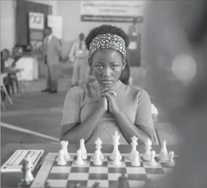  ?? EDWARD ECHWALU, WALT DISNEY PICTURES ?? Ugandan actress Madina Nalwanga as Phiona Mutesi in the movie Queen of Katwe. The film explores the true story of Mutesi’s unlikely rise from a girl in a Kampala slum to become a world-class chess player, all while still a teenager. Columnist Thomas...