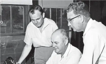  ?? THE COMMERCIAL APPEAL FILES ?? P.A. Gates Jr., center, president of Gates Lumber Co., talks over the sale of the company with R.F. Sharp Jr., left, secretary and assistant treasurer of North Memphis Lumber Co., and Max Pinkerton, North Memphis president, which purchased the company. The sale took place in July 1955.
