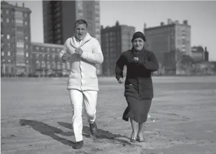  ?? CHICAGO HERALD AND EXAMINER ?? Boxer King Levinsky and his sister who managed him, Lena Levy, run together in 1932.