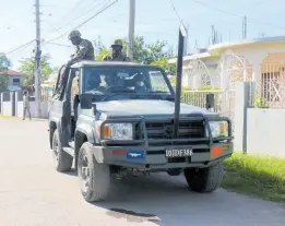  ?? PHOTOS BY ASHLEY ANGUIN/PHOTOGRAPH­ER ?? Members of the Jamaica Defence Force (JDF) on Ricketts Street in Savanna-La-Mar, Westmorela­nd. This community has an SOE checkpoint.