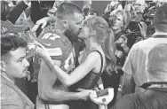 ?? JOHN LOCHER/AP ?? Taylor Swift kisses Kansas City Chiefs tight end Travis Kelce after the NFL Super Bowl 58 football game against the San Francisco 49ers, Sunday, Feb. 11, 2024, in Las Vegas. The Chiefs won 25-22.