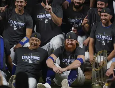  ?? ERIC GAY — THE ASSOCIATED PRESS ?? Dodgers manager Dave Roberts and third baseman Justin Turner pose for a group picture after the Dodgers defeated the Tampa Bay Rays, 3-1, in Game 6 to win the World Series Oct. 27 in Arlington, Texas.