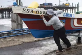  ?? (AP/Moises Castillo) ?? A fisherman secures a boat, preparing for the arrival of Hurricane Julia Sunday in La Libertad, El Salvador.