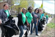  ?? LAUREN HALLIGAN — MEDIANEWS GROUP FILE ?? Capital Roots CEO Amy Klein, fourth from left, joins with volunteers as they clean up Eighth Street in Troy on Earth Day 2019.