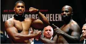  ??  ?? Anthony Joshua and Carlos Takam at the weigh-in ahead of tonight’s world heavyweigh­t title fight in Cardiff
