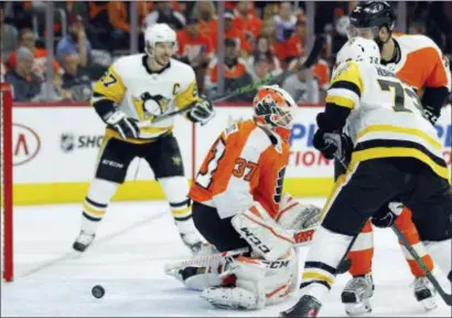  ?? TOM MIHALEK — THE ASSOCIATED PRESS ?? The puck bounces back out of the net behind Flyers goalie Brian Elliott after the Penguins’ Justin Schultz, not pictured, scored a power play goal during the third period in Sunday’s Game 3 of the first-round playoff series between the teams. The guy...
