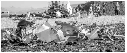  ??  ?? Rescue workers at Bishoftu, or Debre Zeit, outside Addis Ababa, Ethiopia, yesterday, where Ethiopia Airlines Flight 302 crashed on Sunday.