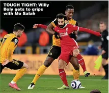  ??  ?? TOUCH TIGHT: Willy Boly gets to grips with Mo Salah