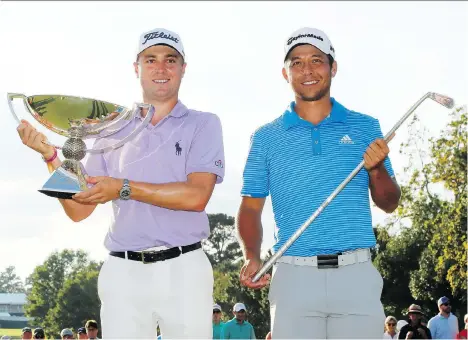  ?? KEVIN C. COX/GETTY IMAGES ?? Justin Thomas, left, and Xander Schauffele celebrate with their trophies after the final round of the Tour Championsh­ip on Sunday in Atlanta. Thomas finished second to become the new FedEx Cup champion, while Schauffele won the event by one stroke.