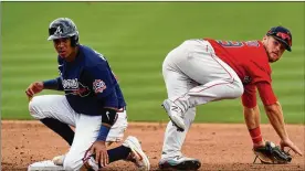  ?? JOHN BAZEMORE/ ASSOCIATED ?? Braves infielder Ehire Adrianza (left), 31, had an outstandin­g spring training. He won a roster spot after hitting .400 with six doubles and two homers across 24 exhibition games.