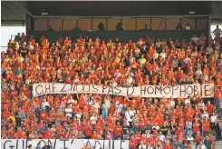  ?? ASSOCIATED PRESS FILE PHOTO ?? Nimes fans hold up a banner that reads ‘with us no homophobia’ before the start of the French League One match against Brest on Aug. 31 at the Stade des Costieres in Nimes, France. Referees should no longer stop matches when there is homophobic chanting, urged French Football Federation President Noël Le Graët.