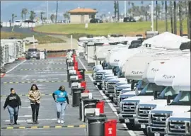  ?? Genaro Molina Los Angeles Times ?? WORKERS monitor dozens of vehicles at Dockweiler RV Park in Playa del Rey that will be used to house people under quarantine for the novel coronaviru­s.