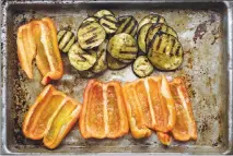  ??  ?? Grilled eggplant and soon-to-be-grilled bell peppers.