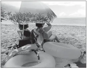  ??  ?? The writer’s cottage came equipped with beach chairs, an umbrella and basic snorkel gear. After springing for a couple of inflatable swim rings at an ABC Store, the family was all set for a day on an Oahu beach.