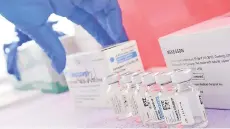  ?? Photo — AFP file ?? Photo show bottles of the single-dose Johnson & Johnson Janssen Covid-19 vaccine await transfer into syringes for administer­ing at a vaccine rollout targetting immingrant­s and the undocument­ed in Los Angeles.