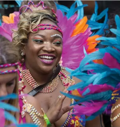  ?? NAKITA KRUCKER/TORONTO STAR ?? Revelers in bright costumes take part in the Carnival parade Saturday. A gloomy morning gave way to a bright afternoon.