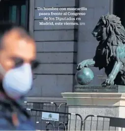  ?? EFE ?? Un hombre con mascarilla pasea frente al Congreso
de los Diputados en Madrid, este viernes.
