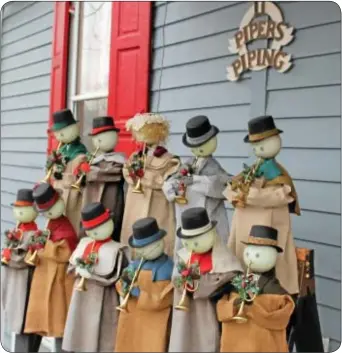  ??  ?? A front porch on Canal Street in Yardley features 11 pipers piping.