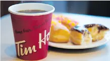  ?? JONATHAN HAYWARD/THE CANADIAN PRESS ?? Tim Hortons’s distributi­on system changes are expected to create 150 jobs and streamline restaurant operations to provide a uniform standard of service nationwide.