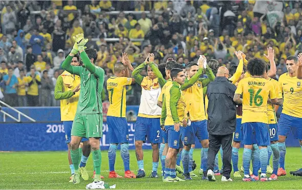  ??  ?? Brazilian players celebrate after their World Cup qualifier against Paraguay.