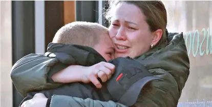  ?? ?? Reunion: Azovstal worker Valeria hugs her son Matvey, who was evacuated to the village earlier