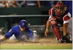  ?? AP/NICK WASS ?? Chicago’s David Bote (left) slides home on a single by Taylor Davis ahead of a throw to Washington catcher Pedro Severino during the 10th inning Thursday of the Cubs’ 6-4 victory over the Nationals in Washington.