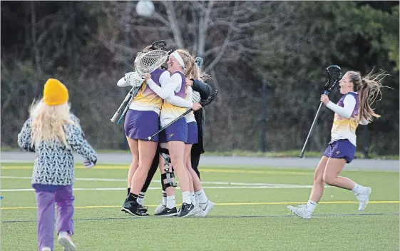  ?? JESSICA NYZNIK EXAMINER ?? The Laurier Golden Hawks celebrate their win over the Trent Excaliburs during semi-final action in the OUA Championsh­ips at Trent University on Saturday. Laurier beat Trent 8-7.