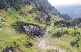  ?? CATHERINE HICKSON, B.C. MINISTRY OF ENVIRONMEN­T AND CLIMATE CHANGE ?? The cave in a remote valley in Wells Gray Provincial Park. The entrance was nicknamed “Sarlacc’s Pit,” a term from a Star Wars movie, by the helicopter crew who discovered it.