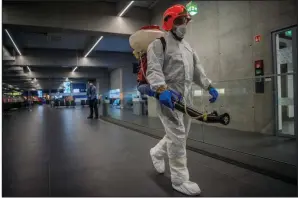  ?? (AP/Zoltan Balogh) ?? Disinfecti­on equipment is carried by a worker as precaution­ary measures against the spreading of new coronaviru­s at Budapest Liszt Ferenc Internatio­nal Airport in Hungary, last week. Almost 900 passengers arriving directly from China have been examined at the airport.