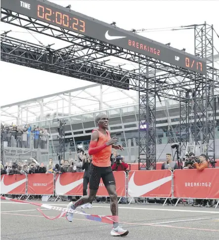  ?? LUCA BRUNO/THE ASSOCIATED PRESS ?? Olympic marathon champion Eliud Kipchoge crosses the finish line at the Monza Formula One racetrack in Italy earlier this month with a time of two hours and 25 seconds. Nike is leading a push for a two-hour marathon.