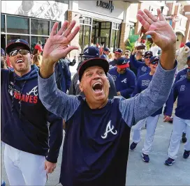  ?? CURTIS COMPTON / CCOMPTON@AJC.COM ?? Braves manager Brian Snitker (front, waving to fans with Freddie Freeman before the home opener) would rather avoid a one-game playoff.