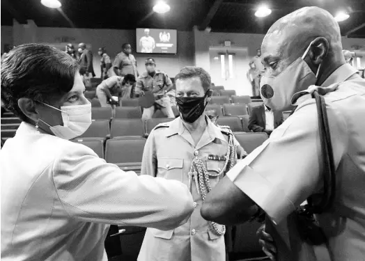  ?? RUDOLPH BROWN/PHOTOGRAPH­ER ?? Dr Luz Longsworth (left), pro vice-chancellor and principal of The University of the West Indies Open Campus, greets Brigadier Radgh Mason, president of the Caribbean Military Academy, at the launch of the academy’s website at Up Park Camp in Kingston on Tuesday. Looking on is Lt Col Simon Westlake, United Kingdom defence attaché to the Caribbean,