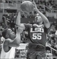  ?? AP/RAYMOND THOMPSON ?? LSU guard Tim Quarterman (55) drives past West Virginia forward BillyDee Williams (21) during a game Thursday in Morgantown, W.Va. Quaterman scored 21 points and LSU won 74-73.