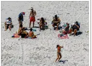  ?? ANDREW MILLS / NJ ADVANCE ?? New Jersey Gov. Chris Christie, right, joins family and friends at Island Beach State Park on Sunday. Christie is defending his use of the beach, closed during the state’s government shutdown, saying he had previously announced his vacation plans.